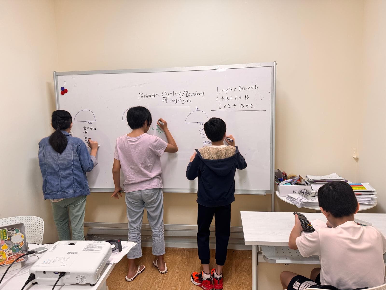 MathArchery students working at the whiteboard